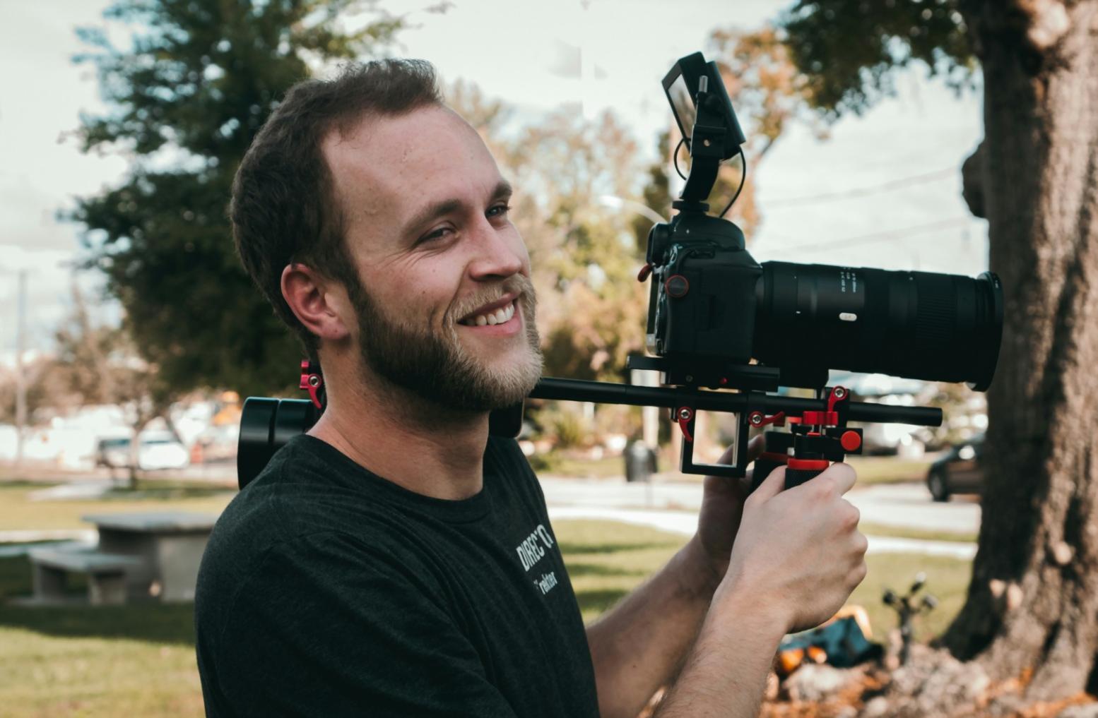 Professional film editing workspace with multiple monitors displaying video timeline and color grading interface